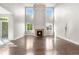 Living room with fireplace and large windows providing natural light, as well as hardwood floors at 23870 E Dorado Pl, Aurora, CO 80016