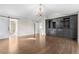 This main bedroom features hardwood floors, a chandelier, and a custom entertainment center and closet at 23870 E Dorado Pl, Aurora, CO 80016