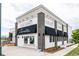 View of a modern commercial building offering pizza, ice cream, wine, and beer with outdoor seating at 6307 Dayton Ct, Denver, CO 80238
