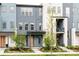 Contemporary townhome exterior with a blue facade and orange door at 6307 Dayton Ct, Denver, CO 80238