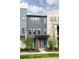 Modern townhome showcasing a blue facade with an orange front door at 6307 Dayton Ct, Denver, CO 80238