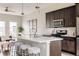 Bright, modern kitchen with an island, stainless steel appliances, and an open layout at 6307 Dayton Ct, Denver, CO 80238
