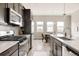 Contemporary kitchen with stainless steel appliances, sleek countertops, and dark wood cabinets at 6307 Dayton Ct, Denver, CO 80238