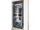 Modern, stacked washer and dryer unit in a closet at 6307 Dayton Ct, Denver, CO 80238