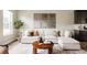 Comfortable living room with a white sectional sofa, wood coffee table, and stylish decorations at 6307 Dayton Ct, Denver, CO 80238
