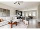 Spacious living room and kitchen area with hardwood floors, modern furnishings and ample natural light at 6307 Dayton Ct, Denver, CO 80238