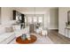 Open floor plan with a stylish living room flowing into the kitchen and dining area at 6307 Dayton Ct, Denver, CO 80238