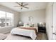 Cozy main bedroom with a comfortable bed, stylish lamps, ceiling fan, and soft natural light at 6307 Dayton Ct, Denver, CO 80238
