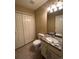 Cozy bathroom featuring a sink with a stone countertop and a built-in cabinet and tiled floors at 19193 E Amherst Dr, Aurora, CO 80013