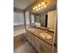 This bathroom has dual sinks, granite countertops and many lights at 19193 E Amherst Dr, Aurora, CO 80013