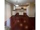 Bright kitchen with hardwood floors, white cabinetry, and a kitchen island at 19193 E Amherst Dr, Aurora, CO 80013