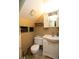 Cozy bathroom with white vanity, toilet, woven basket accents and built-in wall storage at 7978 Chase Cir # G, Arvada, CO 80003
