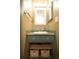 Well-lit bathroom features a pedestal sink, decorative drawers, and a framed mirror at 7978 Chase Cir # G, Arvada, CO 80003