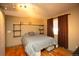Comfortable bedroom featuring a bed, window with coverings, and industrial-style shelving at 7978 Chase Cir # G, Arvada, CO 80003
