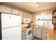 Functional kitchen with essential appliances, butcher block counters, and ample storage at 7978 Chase Cir # G, Arvada, CO 80003