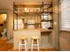 Kitchen with breakfast bar, stainless steel appliances, and unique wooden shelving at 7978 Chase Cir # G, Arvada, CO 80003