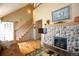 Bright living room with a wooden staircase and a stone fireplace, perfect for relaxing at 7978 Chase Cir # G, Arvada, CO 80003