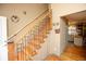 Attractive wooden staircase with iron railings adjacent to a doorway leading to another room at 7978 Chase Cir # G, Arvada, CO 80003
