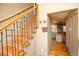 Attractive wooden staircase with iron railings adjacent to a doorway leading to another room at 7978 Chase Cir # G, Arvada, CO 80003