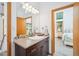 Bathroom featuring a vessel sink, mosaic tile backsplash, and modern lighting at 7350 Timber Trail Rd, Evergreen, CO 80439