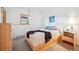 Comfortable bedroom with a side table lamp and light colored wooden furniture at 7350 Timber Trail Rd, Evergreen, CO 80439