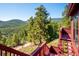 Expansive views from the deck, perfect for enjoying the natural beauty of the surrounding mountains at 7350 Timber Trail Rd, Evergreen, CO 80439