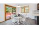 Cozy dining area featuring sliding glass door access to a deck, perfect for outdoor dining at 7350 Timber Trail Rd, Evergreen, CO 80439
