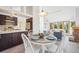 Bright open floor plan features dining room and living room area with a fireplace and lots of natural light at 7350 Timber Trail Rd, Evergreen, CO 80439