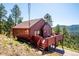 Charming mountain home with a spacious deck offering serene views of the surrounding landscape at 7350 Timber Trail Rd, Evergreen, CO 80439