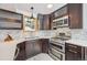 Updated kitchen features stainless steel appliances, a stylish backsplash, and beautiful counters at 7350 Timber Trail Rd, Evergreen, CO 80439