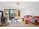 Bright living room offers a fireplace, comfortable seating, and deck access with scenic views at 7350 Timber Trail Rd, Evergreen, CO 80439