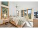 Bright main bedroom with many windows providing lots of natural light and beautiful outdoor views at 7350 Timber Trail Rd, Evergreen, CO 80439