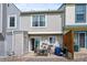 View of the back exterior of the townhome featuring a patio, back door, and muted color palette at 9278 W Ontario Dr, Littleton, CO 80128