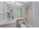 Bathroom featuring an alcove bathtub/shower, sink, and a mirror, with light blue walls at 9278 W Ontario Dr, Littleton, CO 80128