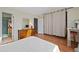 Bedroom featuring wood floors, neutral walls, access to the bathroom and closet space at 9278 W Ontario Dr, Littleton, CO 80128