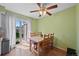 Cozy dining area with a wooden table, chairs, and sliding glass doors to the outside at 9278 W Ontario Dr, Littleton, CO 80128