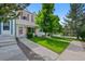 Exterior view of a well maintained townhome with front yard and walkway to the entrance at 9278 W Ontario Dr, Littleton, CO 80128