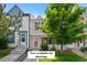Charming townhome featuring a well-maintained lawn, colorful shutters, and mature trees at 9278 W Ontario Dr, Littleton, CO 80128