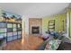Spacious living room with a fireplace, built-in shelving, and a view into the kitchen at 9278 W Ontario Dr, Littleton, CO 80128