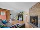 Inviting living room featuring a stone fireplace, hardwood floors, and an open floor plan at 9278 W Ontario Dr, Littleton, CO 80128