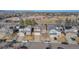 Aerial view of neighborhood with houses and mountain backdrop at 12047 W Coal Mine Dr, Littleton, CO 80127