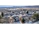 Aerial view of houses in a residential neighborhood with mountain backdrop at 12047 W Coal Mine Dr, Littleton, CO 80127