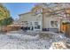 Backyard with patio, deck, and partial snow cover at 12047 W Coal Mine Dr, Littleton, CO 80127