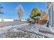 Backyard with patio, umbrella, and snow on the ground at 12047 W Coal Mine Dr, Littleton, CO 80127