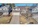 Two-story house with attached garage and landscaping at 12047 W Coal Mine Dr, Littleton, CO 80127