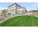Wide-open backyard with pristine lawn space, complimented by rock accents, plants, and a charming fence at 27986 E Frost Pl, Aurora, CO 80016