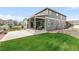 Lovely home showcasing a spacious backyard, lush green lawn, a covered patio, and a gray exterior at 27986 E Frost Pl, Aurora, CO 80016
