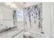 Bright bathroom featuring granite countertop, white cabinets, and a tub with decorative curtain at 27986 E Frost Pl, Aurora, CO 80016