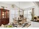 Bright dining room features hardwood floors, chandelier, a large window for natural light, and modern décor at 27986 E Frost Pl, Aurora, CO 80016