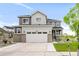 Beautiful two-story home featuring a gray and white exterior, attached two-car garage, and a well-manicured front lawn at 27986 E Frost Pl, Aurora, CO 80016